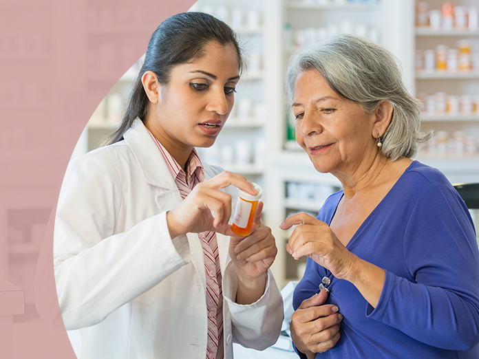 Woman in blue & doctor reviewing medication bottle