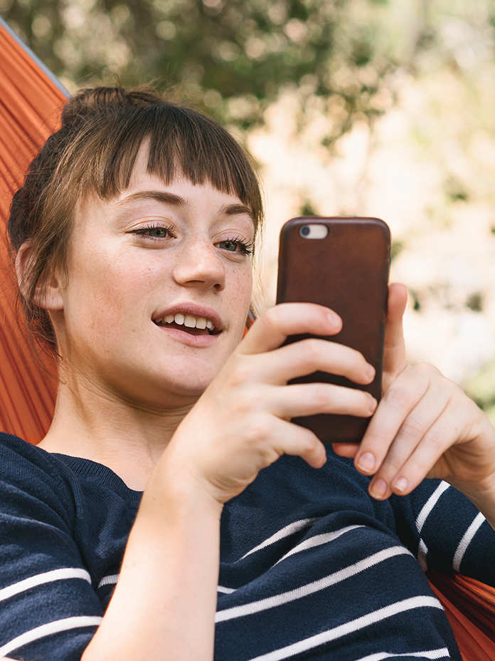 Man in wheelchair looking up at woman smiling